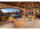 Relaxing patio with comfortable seating, string lights, and a view of the pool at 27256 N 97Th Pl, Scottsdale, AZ 85262