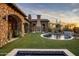 Landscaped backyard with a circular pool and fire feature at 27256 N 97Th Pl, Scottsdale, AZ 85262