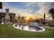 Oval pool and spa with a fire pit and sunset views at 27256 N 97Th Pl, Scottsdale, AZ 85262
