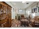 Cozy sitting area with two armchairs and a wooden cabinet at 27256 N 97Th Pl, Scottsdale, AZ 85262
