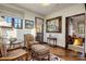 Relaxing sitting area with comfy chairs and a large mirror at 27256 N 97Th Pl, Scottsdale, AZ 85262