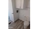 Simple bathroom with toilet, vinyl flooring and white cabinets at 303 S Recker Rd # 126, Mesa, AZ 85206