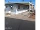 Mobile home with covered carport and desert landscaping at 303 S Recker Rd # 126, Mesa, AZ 85206