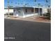 Mobile home with covered carport and desert landscaping at 303 S Recker Rd # 126, Mesa, AZ 85206