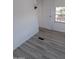 Bright room featuring wood-look vinyl flooring, white walls, and a window at 303 S Recker Rd # 126, Mesa, AZ 85206
