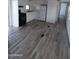 Bright kitchen features white cabinets, wood-look vinyl floors, and modern appliances at 303 S Recker Rd # 126, Mesa, AZ 85206