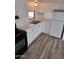 Clean kitchen with white cabinets, light countertops, and vinyl flooring at 303 S Recker Rd # 126, Mesa, AZ 85206
