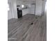 Open living area with grey flooring and access to kitchen at 303 S Recker Rd # 126, Mesa, AZ 85206