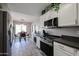 Modern kitchen with white cabinets, stainless steel appliances, and a breakfast nook at 3135 W Pecan Rd, Phoenix, AZ 85041