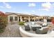 Landscaped backyard with patio, seating area, and fire pit at 3171 N 159Th Ave, Goodyear, AZ 85395