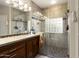 Updated bathroom with granite vanity, walk-in shower, and large mirror at 3171 N 159Th Ave, Goodyear, AZ 85395