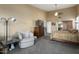 Comfortable Primary bedroom with sitting area and large TV at 3171 N 159Th Ave, Goodyear, AZ 85395