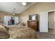 King-size bed in a spacious bedroom with a large TV and patio access at 3171 N 159Th Ave, Goodyear, AZ 85395