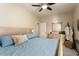 Guest bedroom with a queen bed, ceiling fan, and ample closet space at 3171 N 159Th Ave, Goodyear, AZ 85395