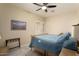 Bedroom with queen bed, window with shutters and ceiling fan at 3171 N 159Th Ave, Goodyear, AZ 85395