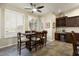 Breakfast nook with wood table and chairs, adjacent to kitchen and wine storage at 3171 N 159Th Ave, Goodyear, AZ 85395