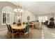 Bright dining room features a wood table with green chairs, and is adjacent to a living room at 3171 N 159Th Ave, Goodyear, AZ 85395