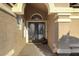Elegant entryway with double doors and decorative planters at 3171 N 159Th Ave, Goodyear, AZ 85395