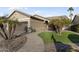 Tan house with landscaped yard and walkway at 3171 N 159Th Ave, Goodyear, AZ 85395