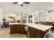 Large kitchen island with granite countertops and dark wood cabinets at 3171 N 159Th Ave, Goodyear, AZ 85395