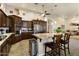 Modern kitchen with granite island, stainless steel appliances, and dark cabinetry at 3171 N 159Th Ave, Goodyear, AZ 85395