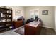 Home office with built-in desk, bookshelves, and window with shutters at 3171 N 159Th Ave, Goodyear, AZ 85395