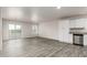 Open living room and kitchen with grey wood-look floors at 3715 N Algodon Dr, Eloy, AZ 85131