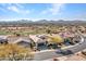 Aerial view of houses with mountain views and golf course at 41933 N Crooked Stick Rd, Anthem, AZ 85086