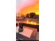 Firepit and seating area in backyard at sunset at 41933 N Crooked Stick Rd, Anthem, AZ 85086