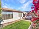 Landscaped backyard with artificial turf and seating area near the house at 41933 N Crooked Stick Rd, Anthem, AZ 85086
