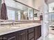 Double vanity bathroom with large mirror and glass block window at 41933 N Crooked Stick Rd, Anthem, AZ 85086
