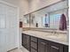 Double vanity bathroom with large mirror and glass block window at 41933 N Crooked Stick Rd, Anthem, AZ 85086