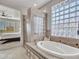 Spa-like bathroom with soaking tub, walk-in shower, and views to bedroom at 41933 N Crooked Stick Rd, Anthem, AZ 85086