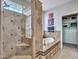 Elegant bathroom with a large walk-in shower, soaking tub, and glass block window at 41933 N Crooked Stick Rd, Anthem, AZ 85086