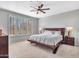Spacious bedroom with a king-size bed, and large windows with shutters at 41933 N Crooked Stick Rd, Anthem, AZ 85086