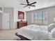 Main bedroom with ceiling fan and large windows at 41933 N Crooked Stick Rd, Anthem, AZ 85086