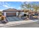 One-story house with brown accents and a two-car garage at 41933 N Crooked Stick Rd, Anthem, AZ 85086