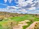 Aerial view of a beautiful golf course with sand traps and desert landscape at 41933 N Crooked Stick Rd, Anthem, AZ 85086