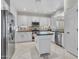 Modern kitchen with white cabinets, granite counters, and island at 41933 N Crooked Stick Rd, Anthem, AZ 85086