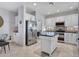 Well-equipped kitchen with island, white cabinets and stainless steel appliances at 41933 N Crooked Stick Rd, Anthem, AZ 85086