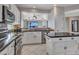Spacious kitchen with island, white cabinets and granite countertops at 41933 N Crooked Stick Rd, Anthem, AZ 85086