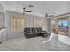 Spacious living room with tile floors, ceiling fan, and access to backyard patio at 41933 N Crooked Stick Rd, Anthem, AZ 85086
