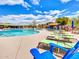Relaxing pool area with lounge chairs and umbrellas at 41933 N Crooked Stick Rd, Anthem, AZ 85086