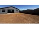 Large backyard with dark gray fence, and freshly filled in area ready for grass or landscaping at 4353 E Bradford Ave, San Tan Valley, AZ 85140
