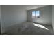 Bright bedroom features a window with outdoor views and abundant natural light at 4353 E Bradford Ave, San Tan Valley, AZ 85140