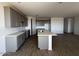 Kitchen with stone countertops, ample cabinet space, a center island, and tile floors at 4353 E Bradford Ave, San Tan Valley, AZ 85140