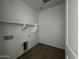 Laundry room with tiled floors, washer and dryer hookups, and a built-in storage shelf at 4353 E Bradford Ave, San Tan Valley, AZ 85140