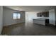 A naturally-lit, open-concept living room with tiled floors seamlessly connects to kitchen and dining spaces at 4353 E Bradford Ave, San Tan Valley, AZ 85140