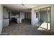 Living room with tiled floors, stone countertops, ample gray cabinets, island, and sliding glass door at 4353 E Bradford Ave, San Tan Valley, AZ 85140