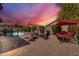 Inviting backyard with a sparkling pool, patio furniture, and a covered seating area at 4628 W Hasan Dr, Laveen, AZ 85339